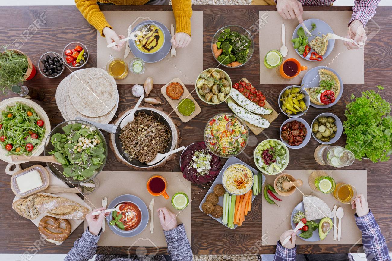 Friends Meeting By The Table Full Of Vegetarian Food Stock Photo Picture And Royalty Free Image Image 72944044