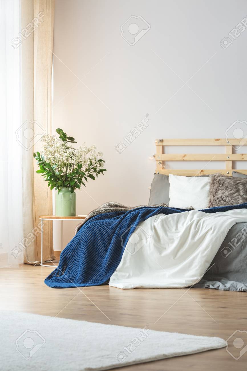 Bright Bedroom Interior Design With Flowers On Nightstand Stock Photo Picture And Royalty Free Image Image 75271051