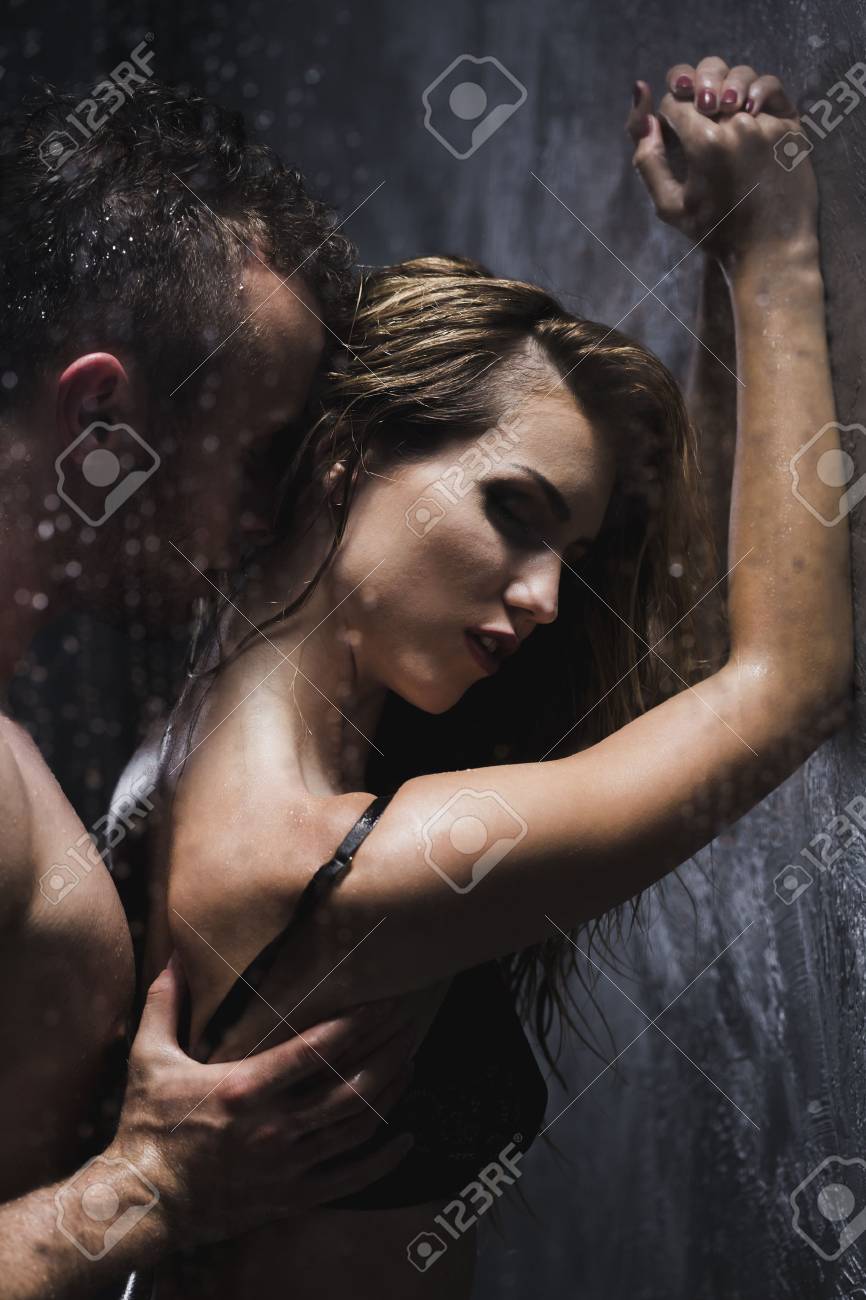 Woman with a man standing behind her during foreplay at the shower - 785044...