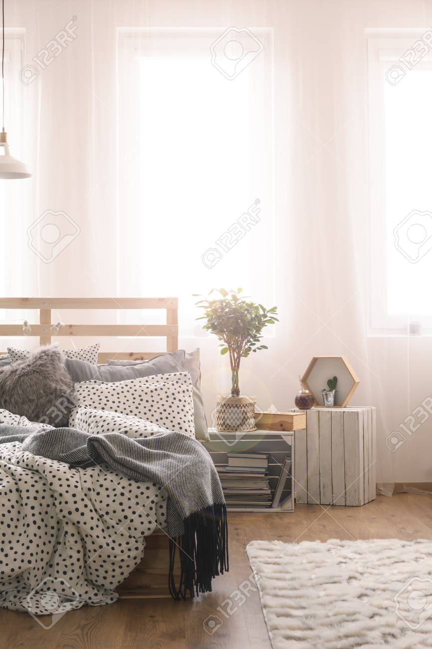 Bedroom With Wooden Pallet Bed Carpet And Window Stock Photo