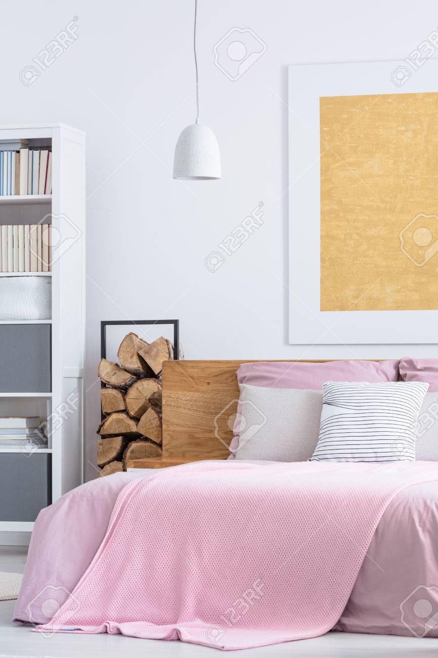 Simple Pink Bedroom With Cozy Big Bed And Wood Supplies