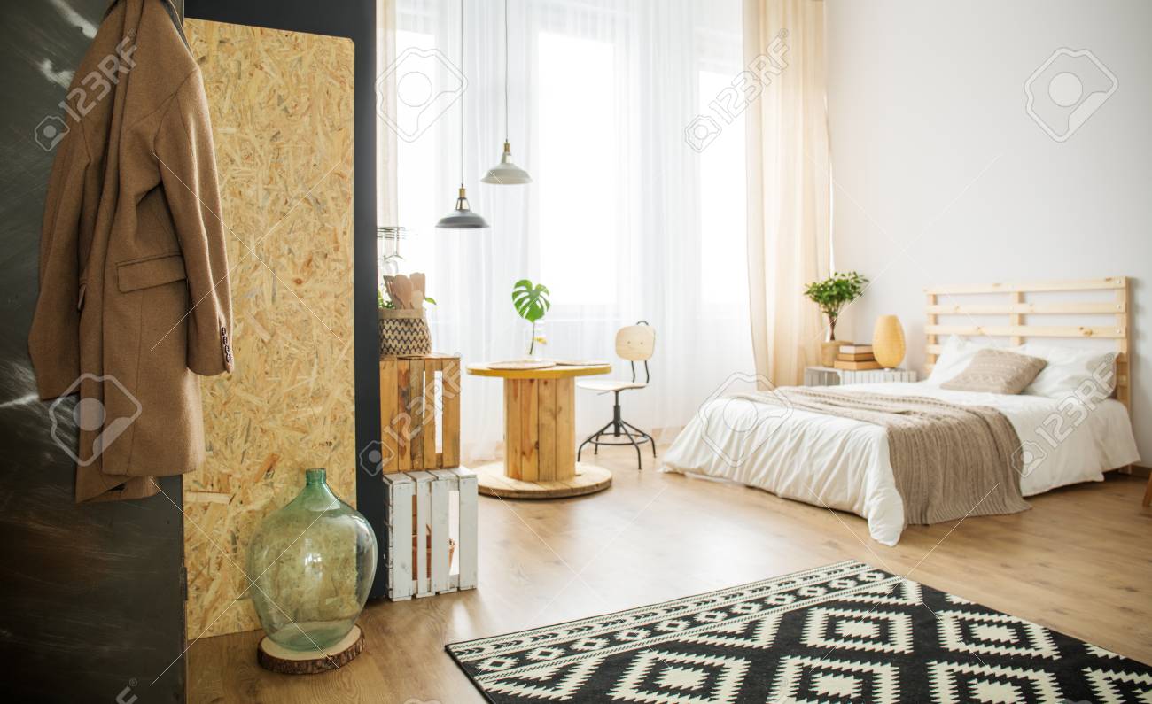 trendy bright bedroom with natural details and diy furniture stock