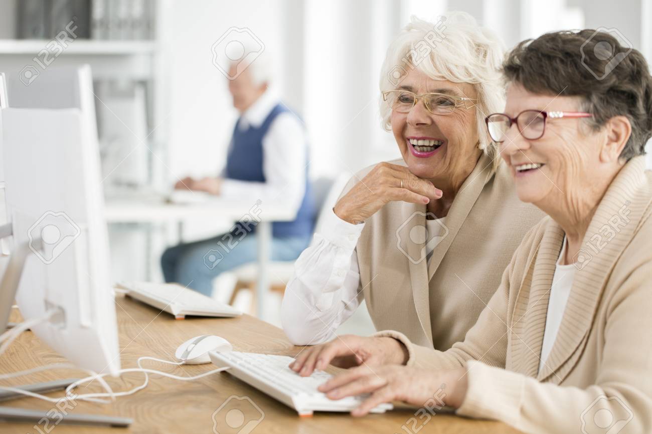 Two elder women with glasses learning how to use computer together - 84606456 Two elder women with glasses learning how to use computer together - 84606456