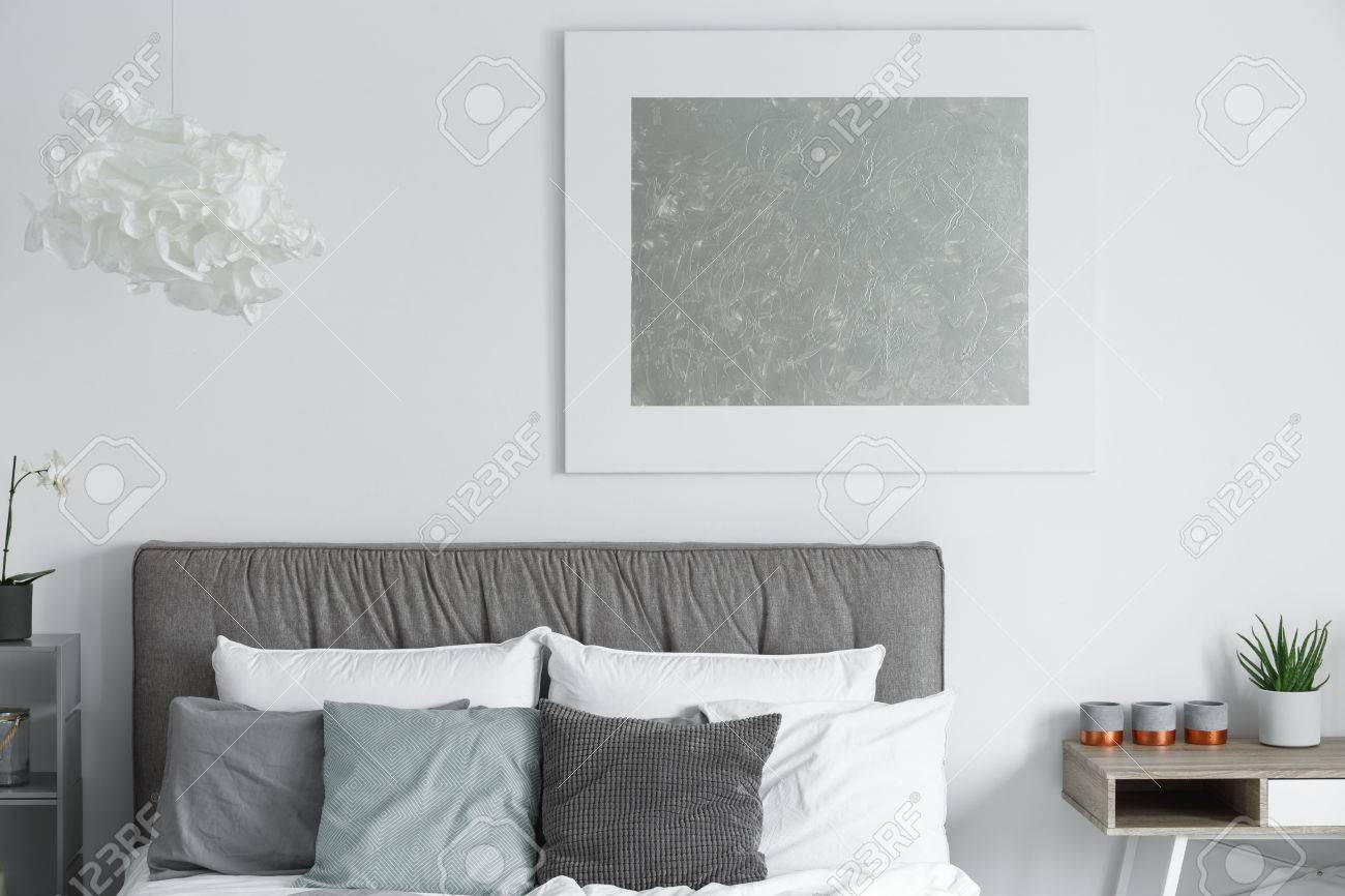 Big Modern Poster Hanging On White Wall In Stylish Bedroom