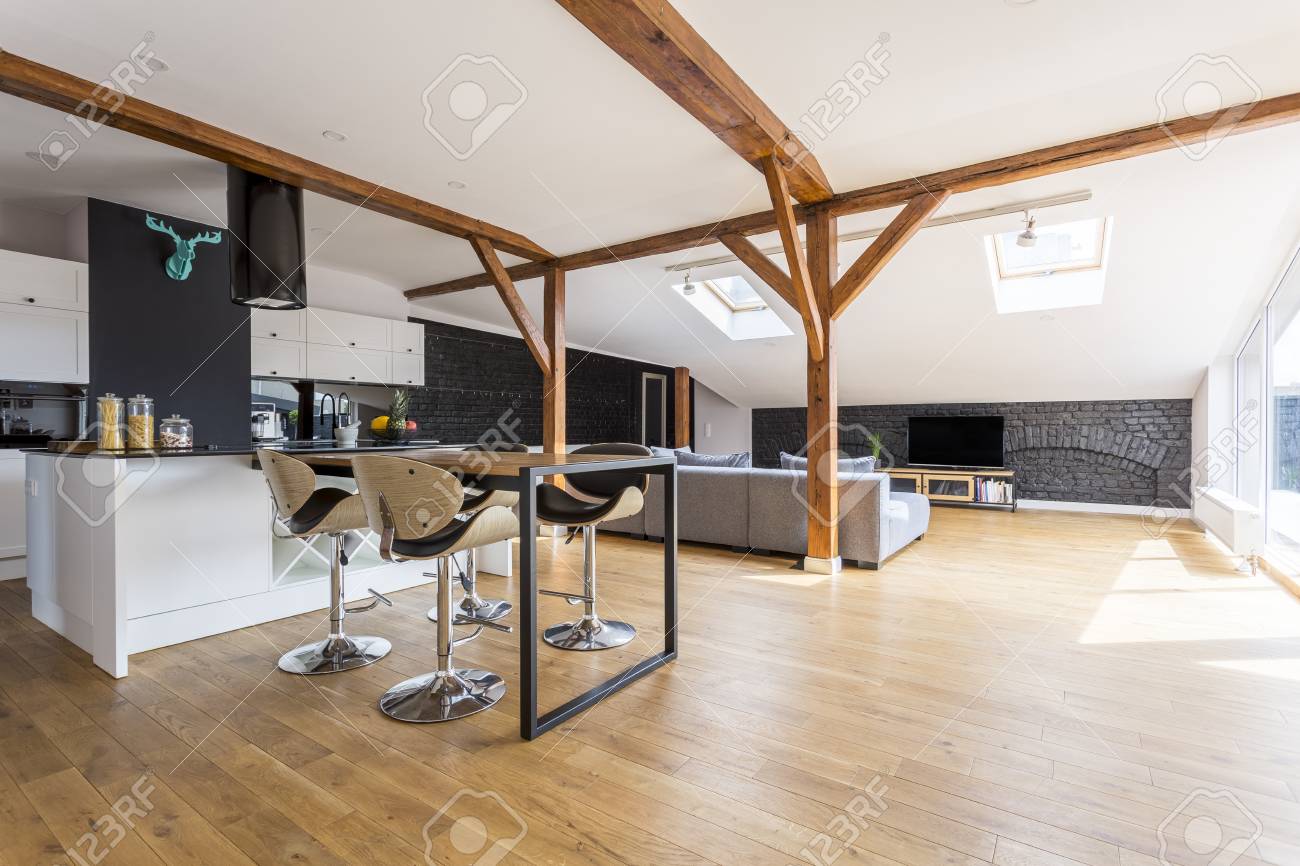 Modern Bar Stools At Dining Table In Spacious Apartment With Stock Photo