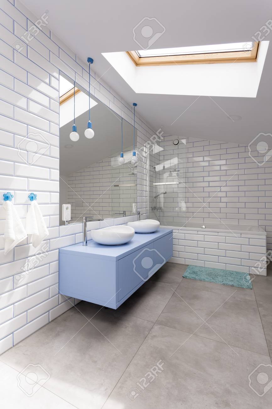 Blue Washbasin Cabinet And Mirror In Simple Bathroom With Glossy