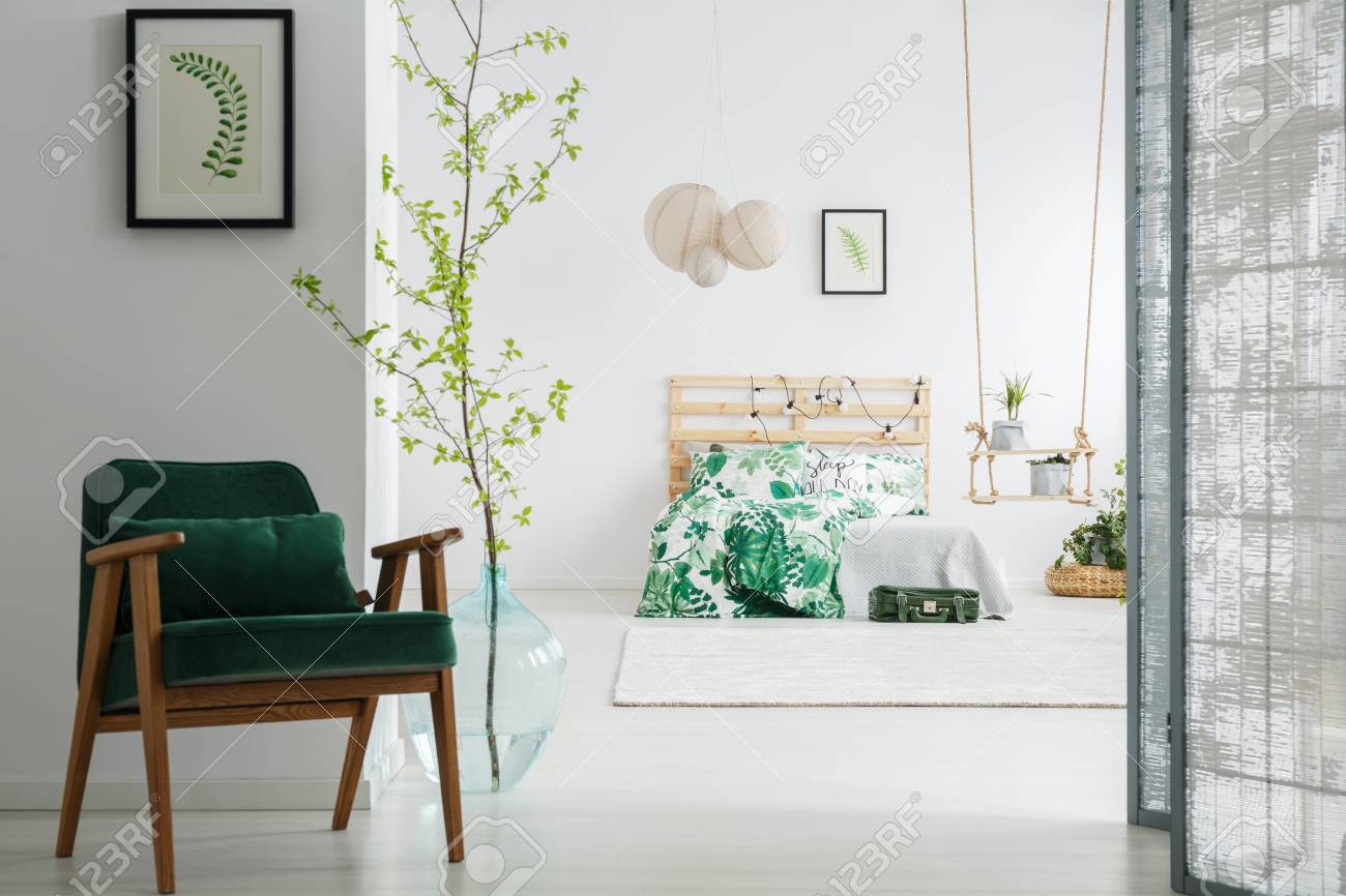 Dark Green Vintage Chair In Cozy Bedroom With Screen And Tree