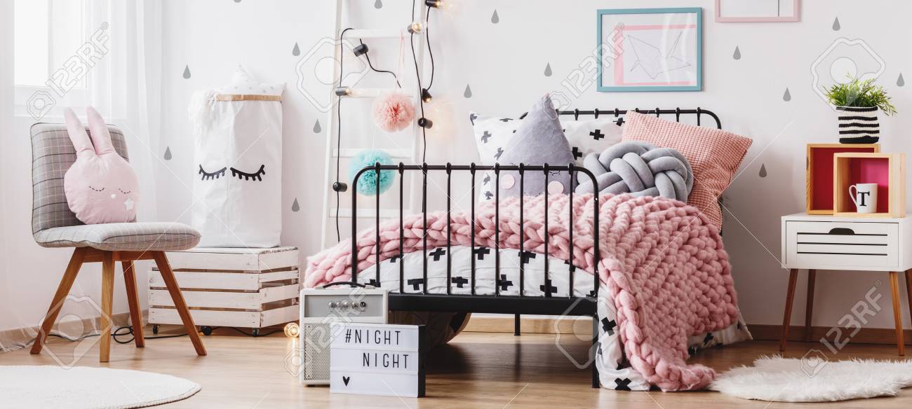 Pink Knit Blanket And Creative Pillows On Bed In Colorful Kids