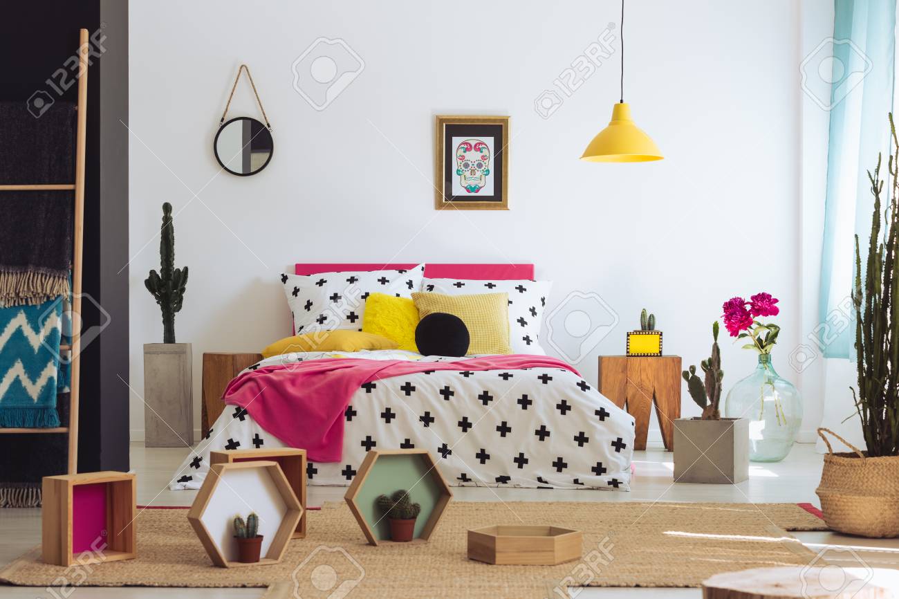 Colorful Mexican Bedroom With Yellow Pillow And Patterned Coverlet
