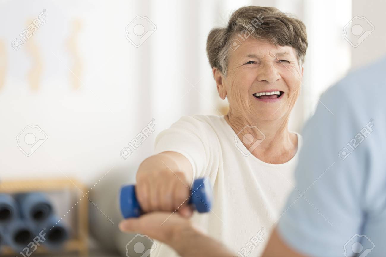 Joint relieving isometric exercises with a blue dumb-bell - 87560716 Joint relieving isometric exercises with a blue dumb-bell - 87560716