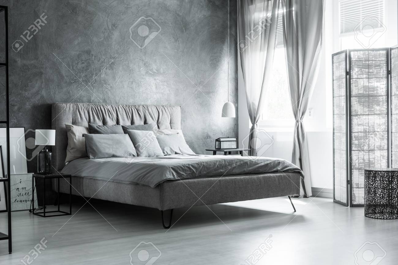 Dark Grey Bedroom With Comfortable King Size Bed Under Window