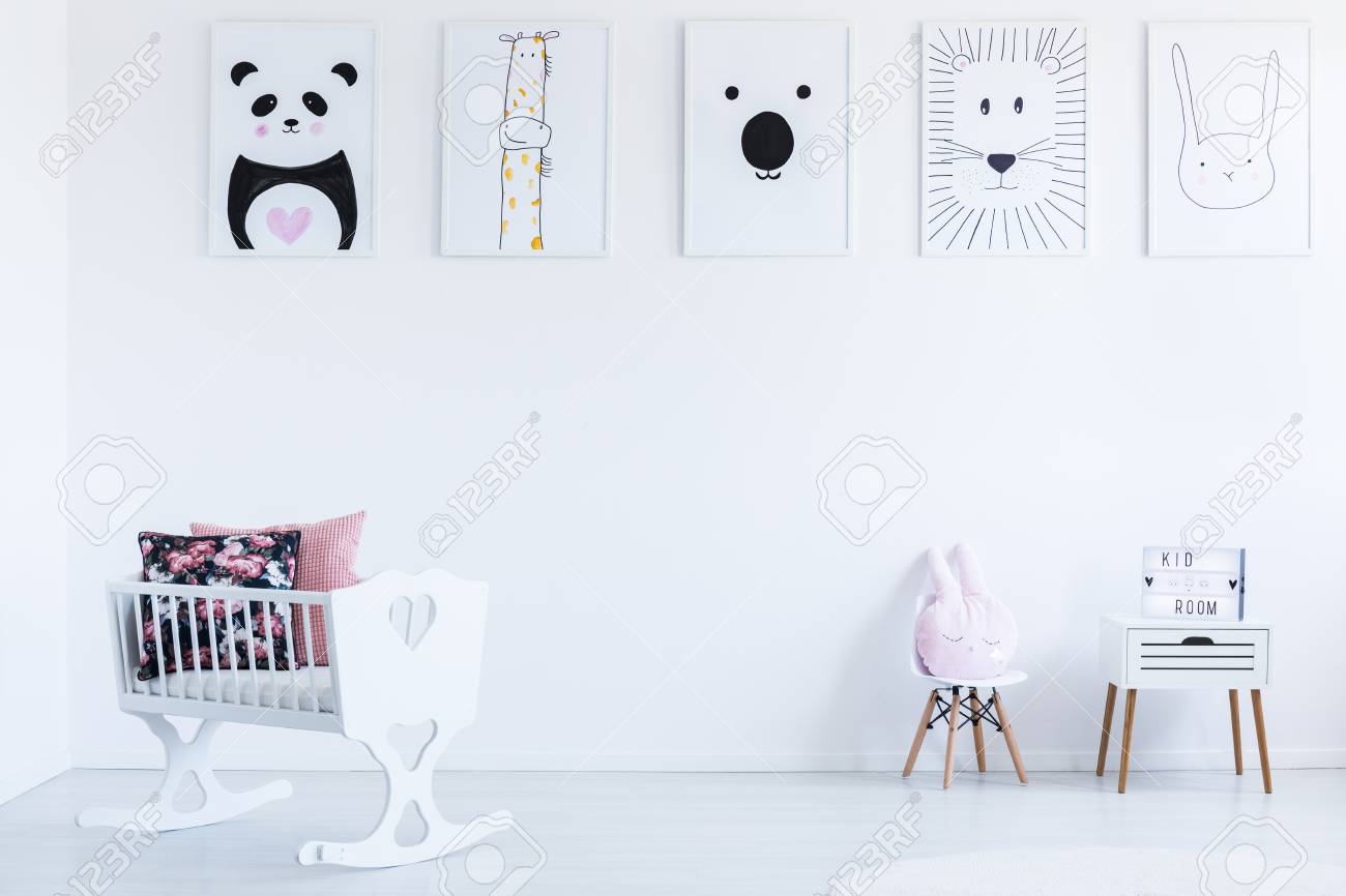 White Cradle With Floral Patterned Pillows In Bright Baby S Bedroom