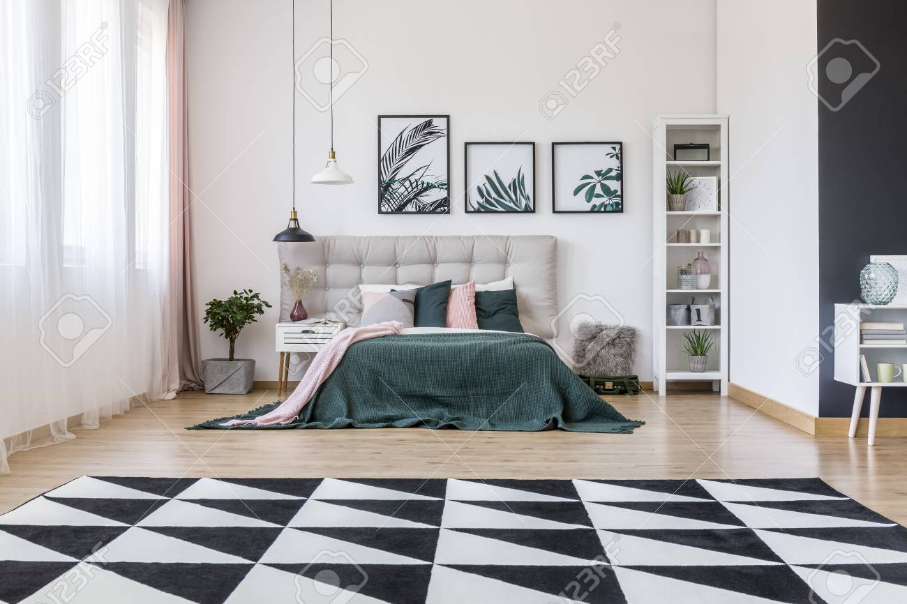 Geometric Carpet In Bedroom Interior With Posters Of Leaves On