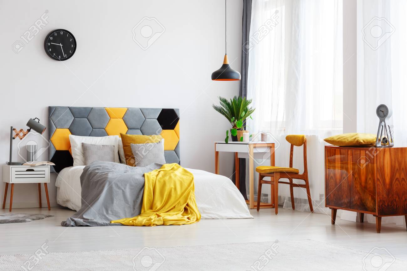 Wooden Cupboard With Clock Next To Chair At Desk In Cozy Bedroom Stock Photo Picture And Royalty Free Image Image 94416152