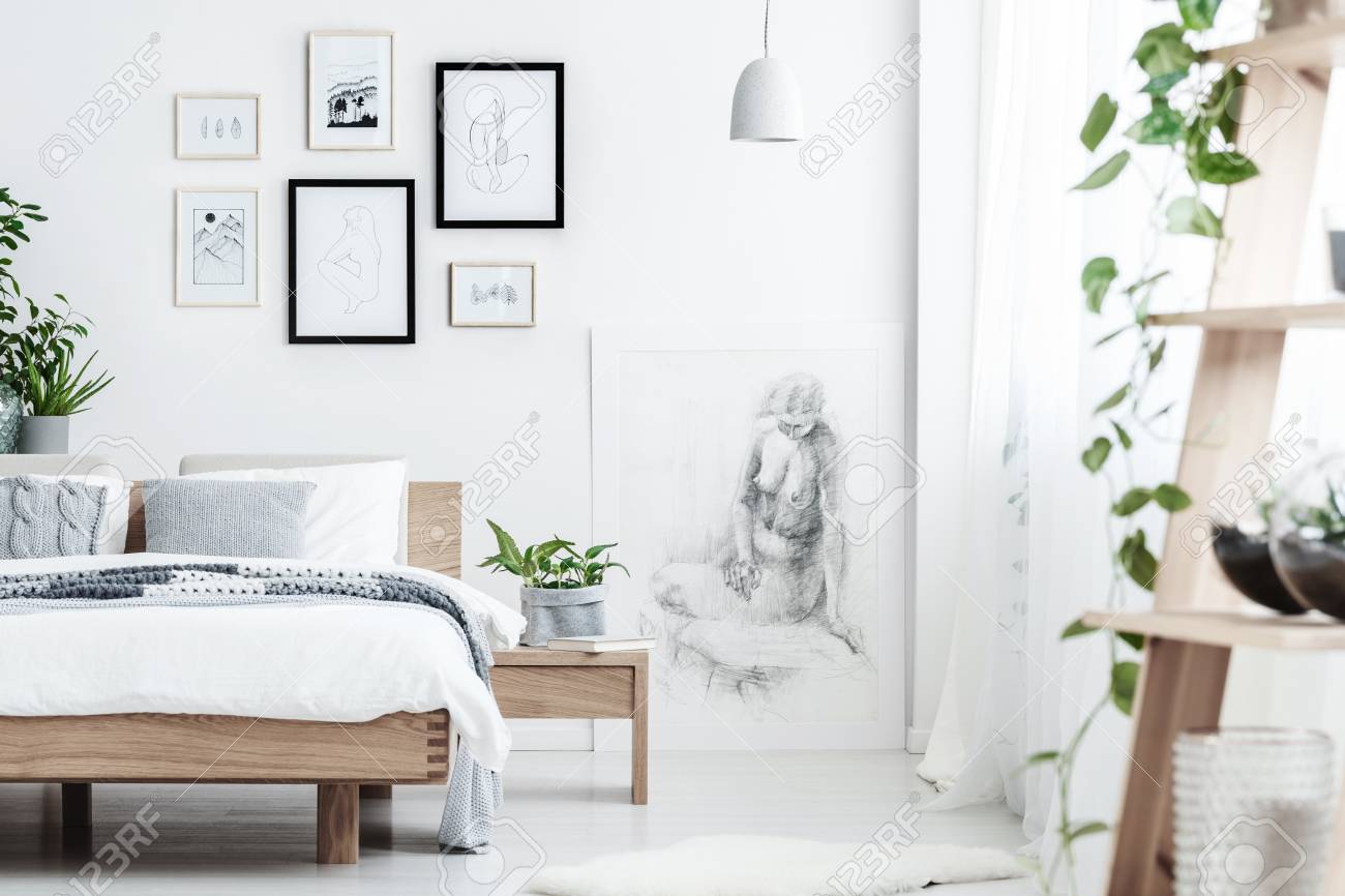 Drawing On White Wall Of Simple Bedroom Interior With Plant On