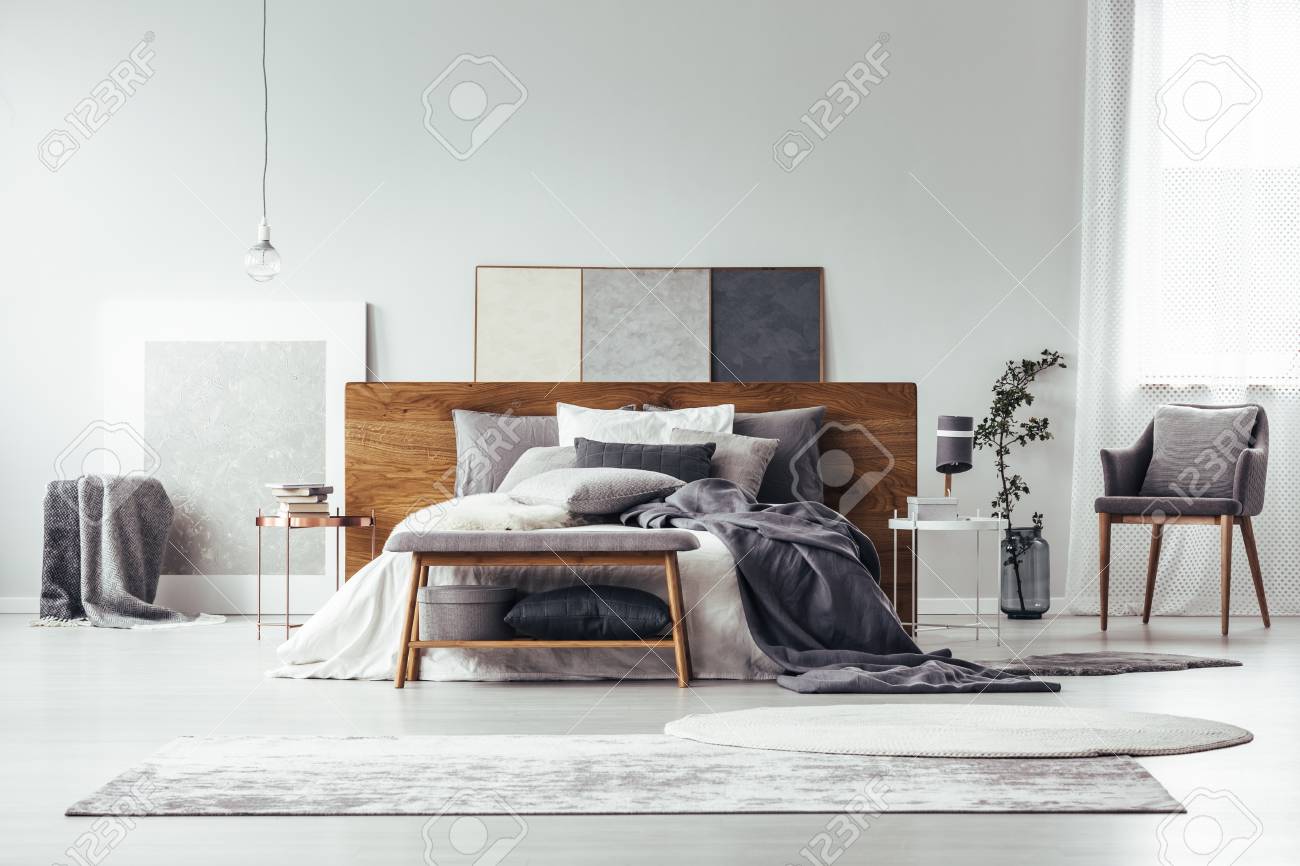 Gray And White Rugs In Monochromatic Bedroom Interior With Wooden