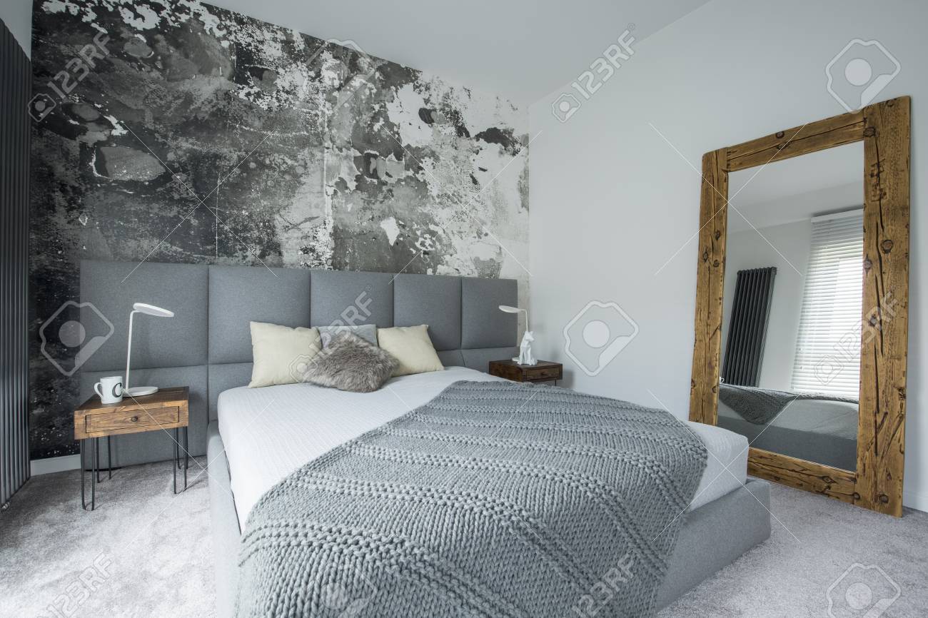 Mirror In Wooden Frame In Modern Bedroom Interior With Bed Next