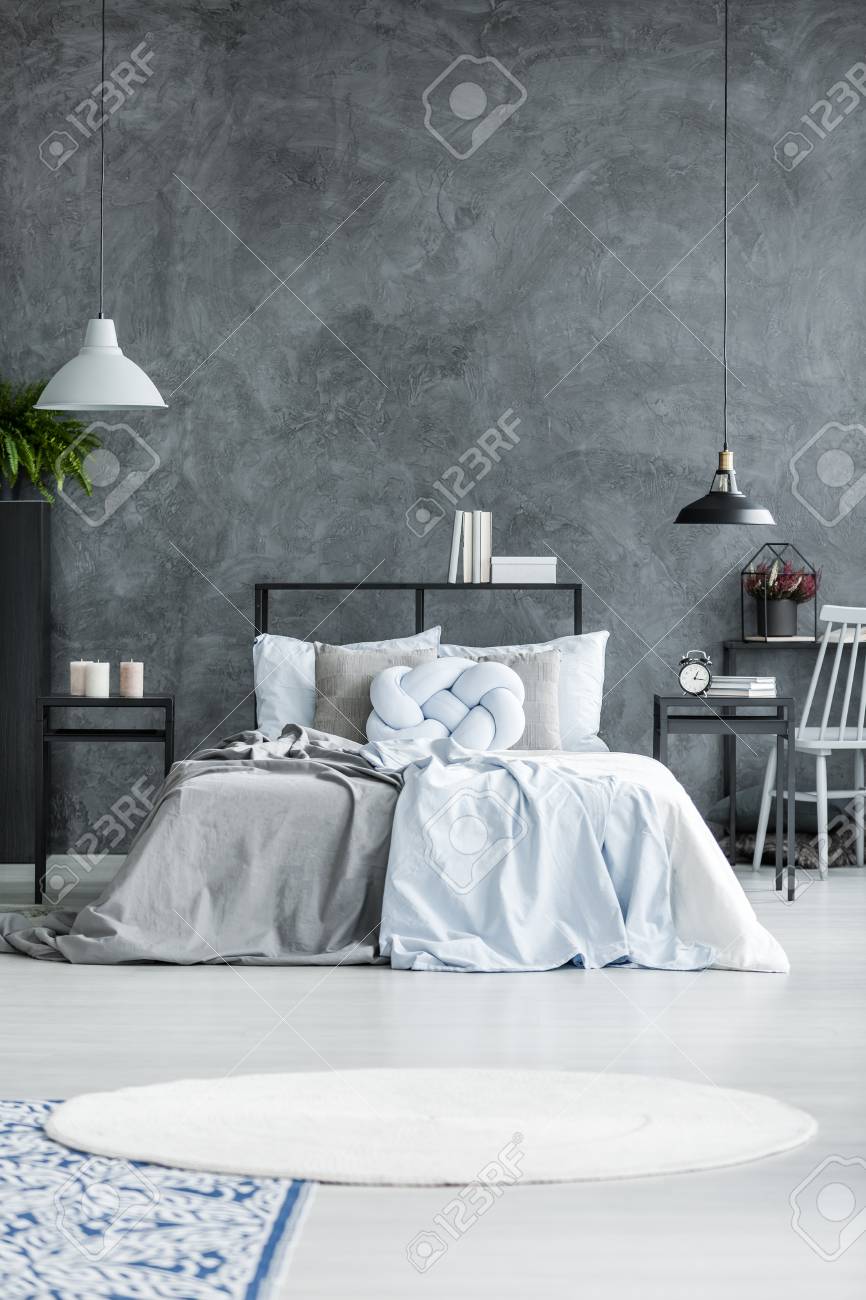 Pastel Blue Bedding And Knot Cushion On A Gray Bed In Bedroom