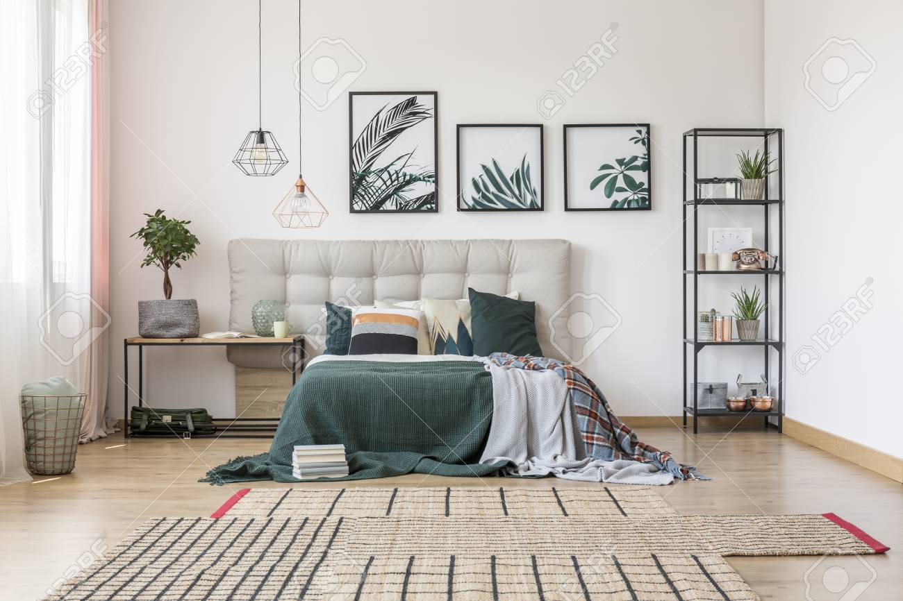 Brown Asymmetrical Carpet And Botanical Posters On The Wall
