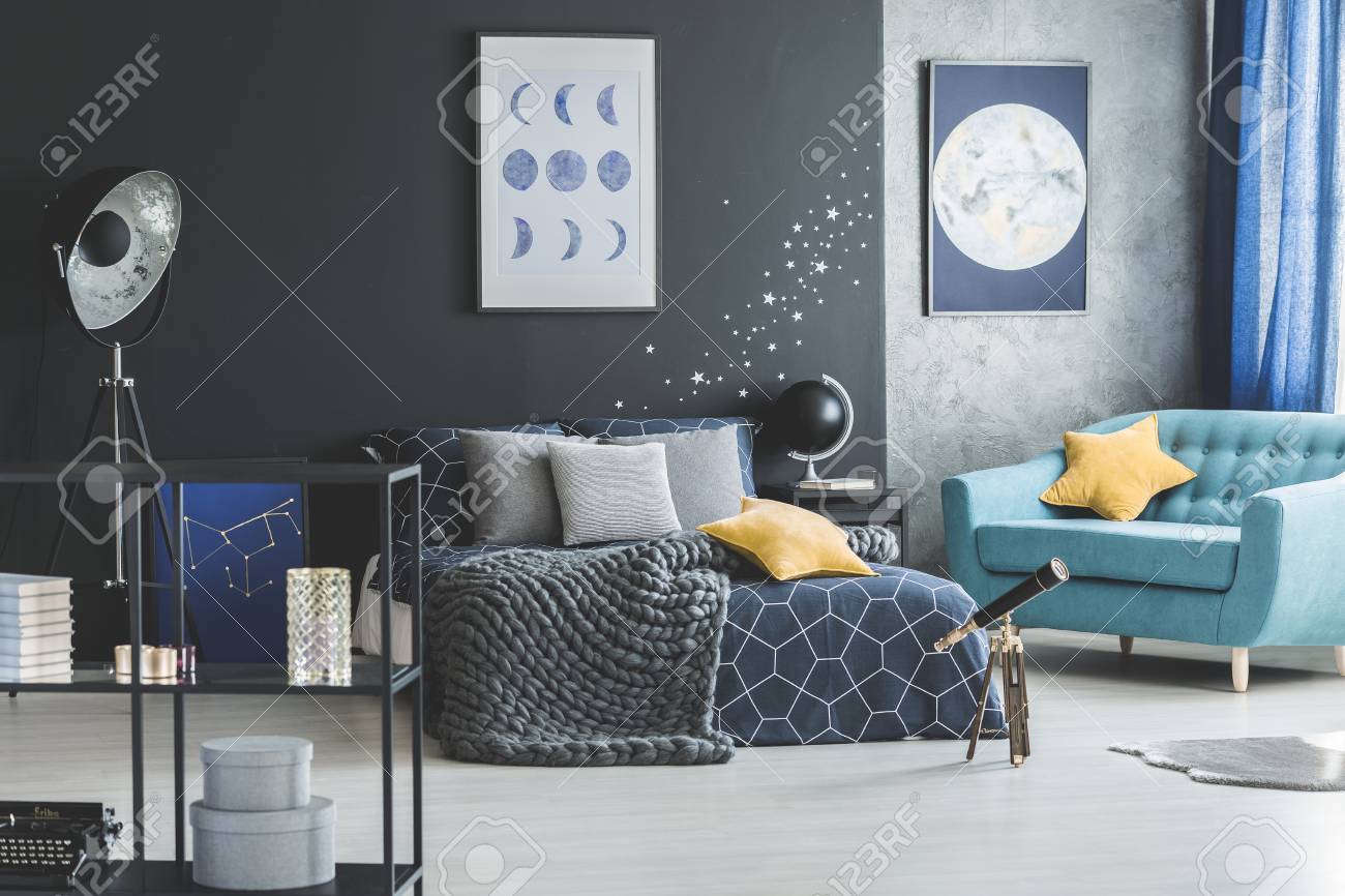 Telescope Next To Bed With Yellow Pillow And Grey Blanket In