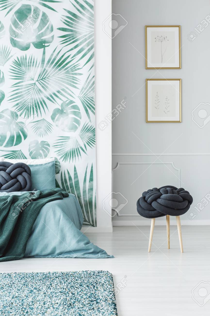 Stool Next To Blue Bed In Bedroom Interior With Leaves Wallpaper