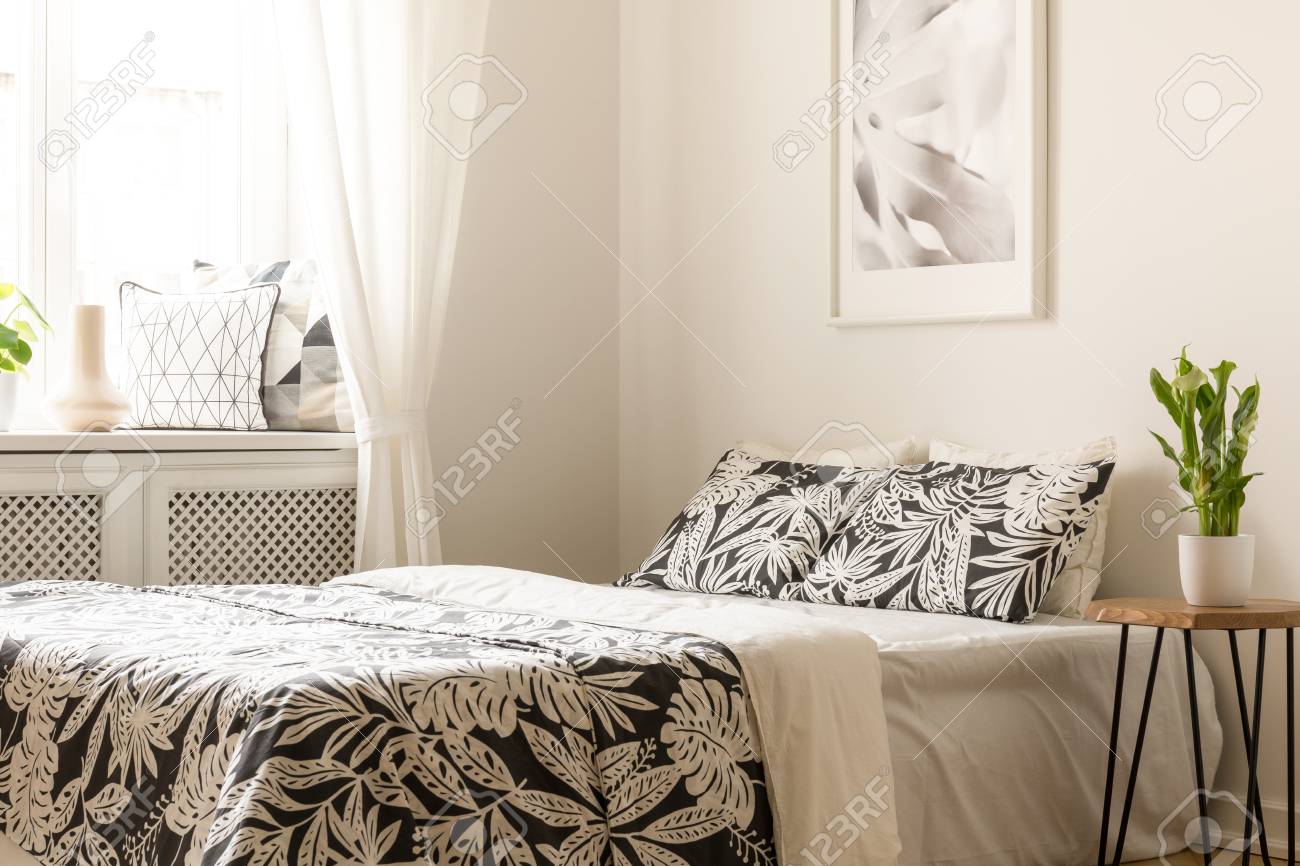 table next to bed study plant on table next to bed with patterned sheets in bright bedroom interior poster on table next to bed with patterned sheets in bright bedroom table next to bed study plant on table next to bed with patterned sheets in bright bedroom interior poster on table next to bed with patterned sheets in bright bedroom