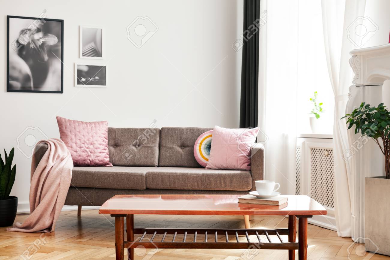 Real Photo Of Couch With Pastel Pink Cushions And Blanket Standing