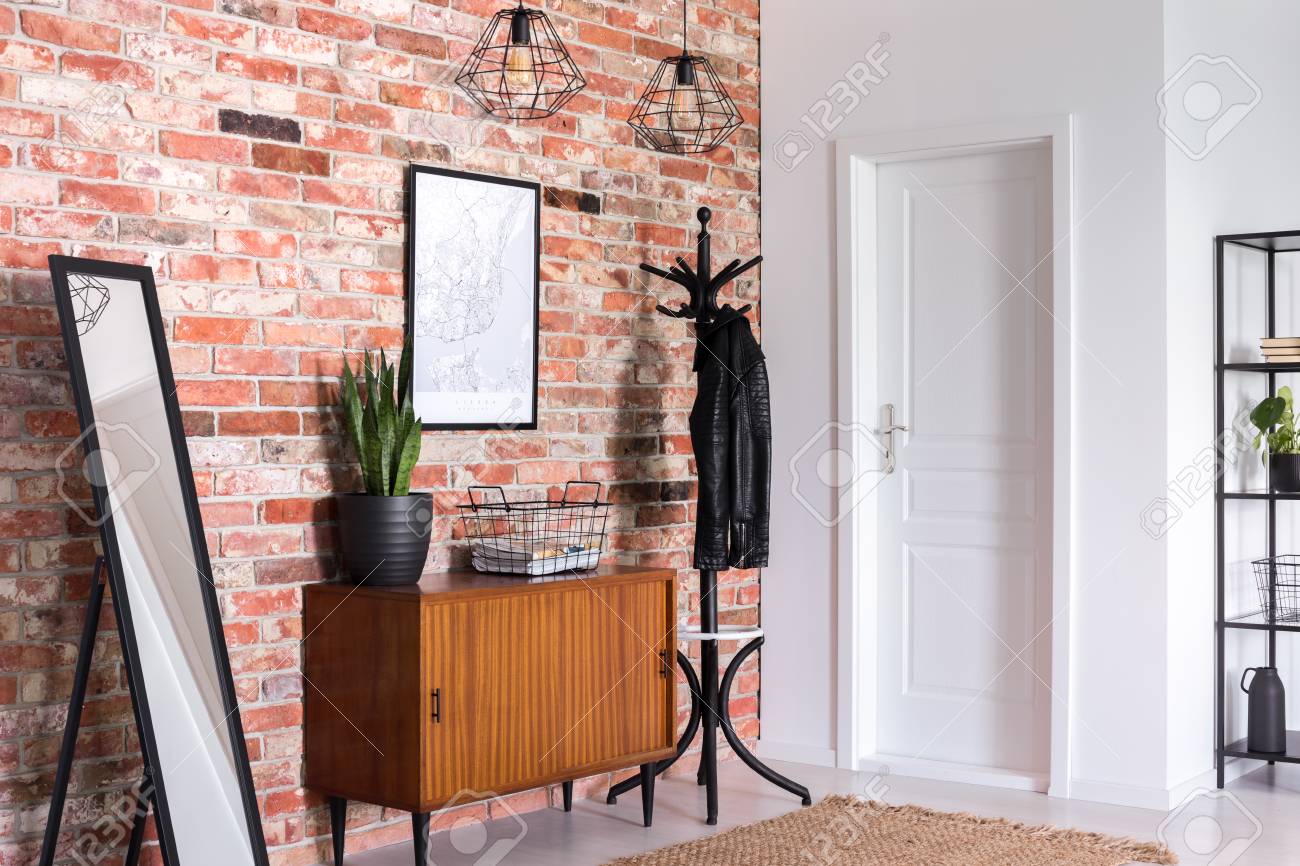 Mirror Next To Wooden Cabinet In Entrance Hall Interior With