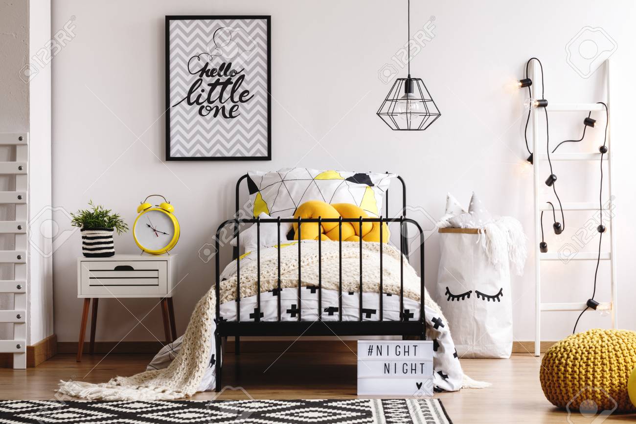 Yellow Knot Pillow On Single Metal Bed In Bright Bedroom Interior Stock Photo Picture And Royalty Free Image Image 115570360