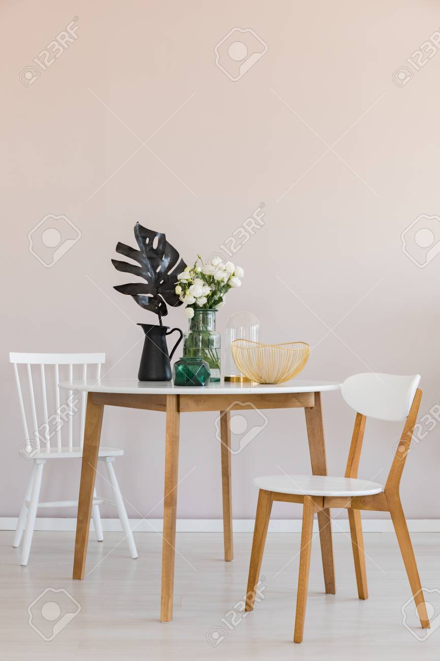 Stylish dining room with round table and elegant chairs, copy space on the empty wall - 121162076 Stylish dining room with round table and elegant chairs, copy space on the empty wall - 121162076