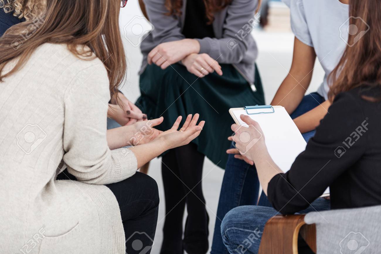 Anonymous women sitting in circle during group meeting - 123114762 Anonymous women sitting in circle during group meeting - 123114762