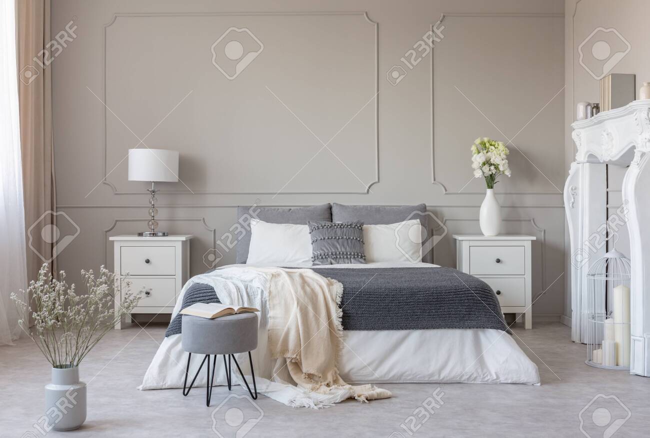 Flowers on nightstand table in delightful bedroom interior with.. Flowers on nightstand table in delightful bedroom interior with..