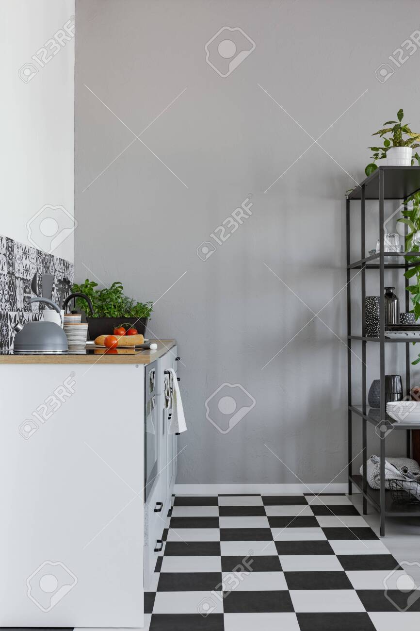 Empty Grey Wall In Small Kitchen With Black And White Floor And Stock Photo