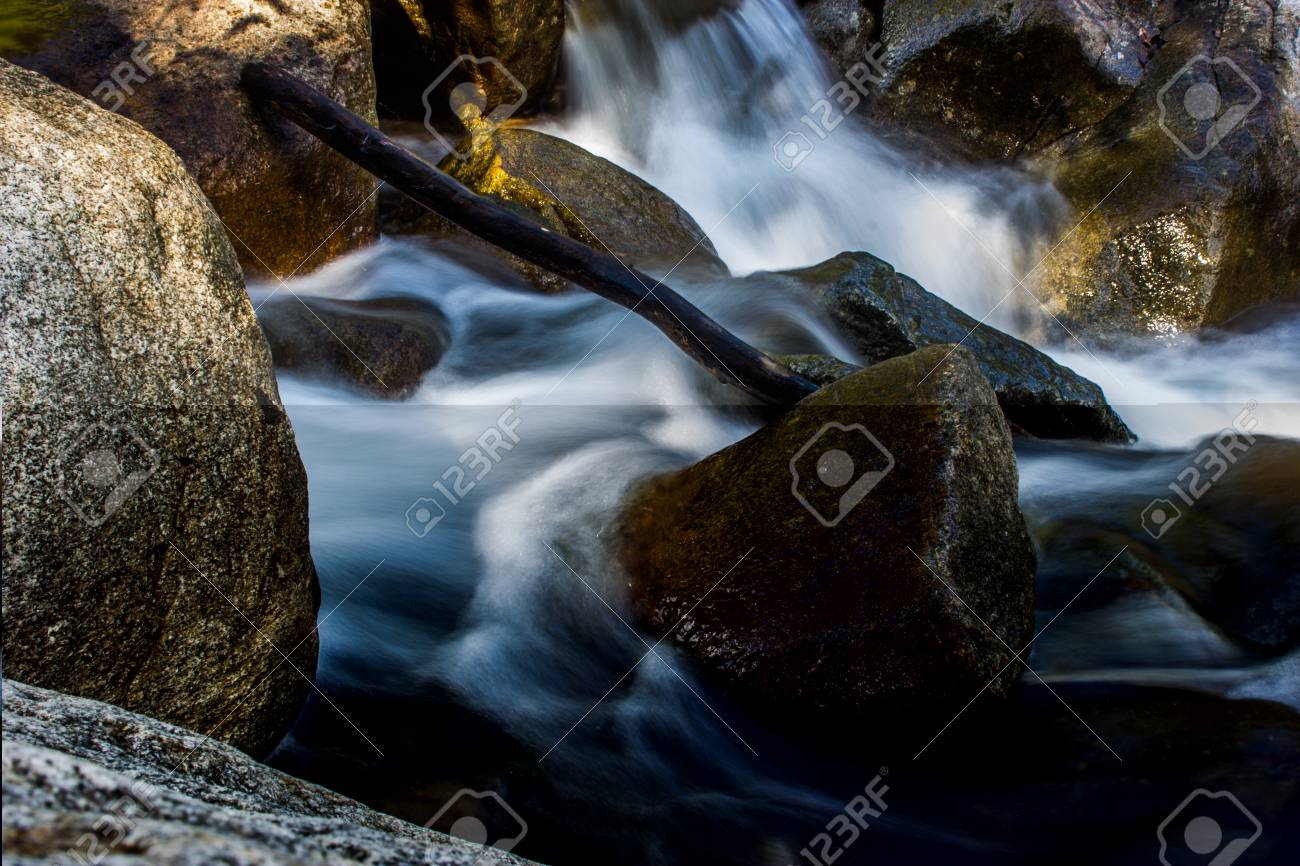 The River in flowing around a rock. - 69968364 The River in flowing around a rock. - 69968364