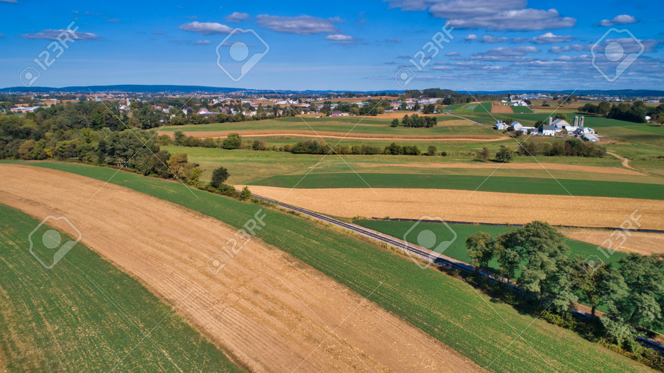 Aerial View of Multiple Farms and Train Tracks going Thru Them on a Beautiful Summer Day - 162633887 Aerial View of Multiple Farms and Train Tracks going Thru Them on a Beautiful Summer Day - 162633887