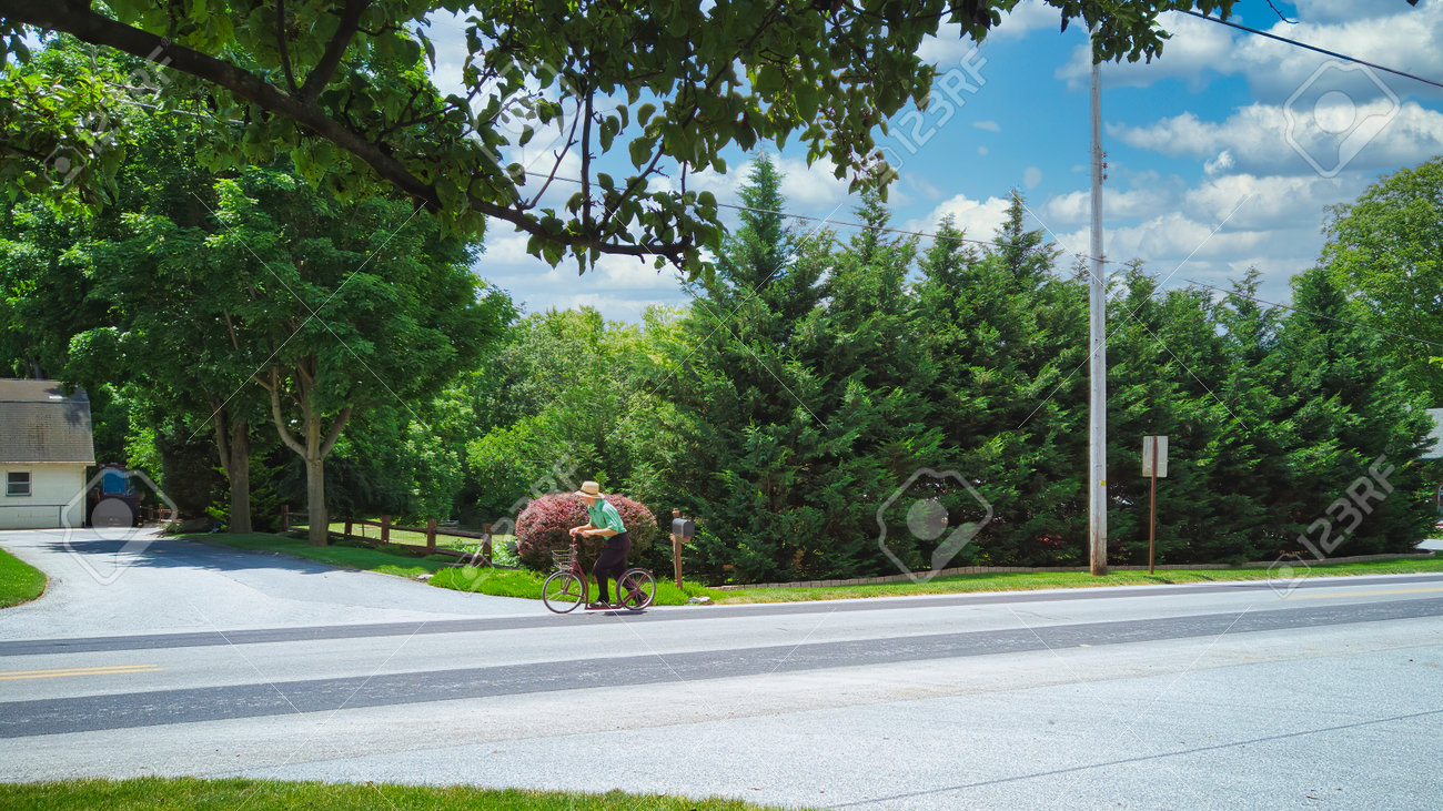 An Amish Boy Riding His Scooter on a Country Road on a Beautiful Summer Day - 162658461 An Amish Boy Riding His Scooter on a Country Road on a Beautiful Summer Day - 162658461