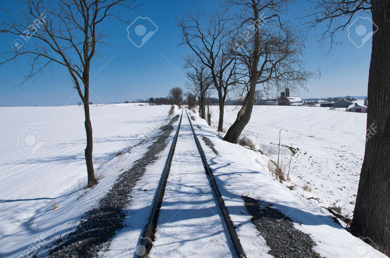 View of Rail Road Tracks Running Thru the Countryside Covered in Snow - 165159665 View of Rail Road Tracks Running Thru the Countryside Covered in Snow - 165159665
