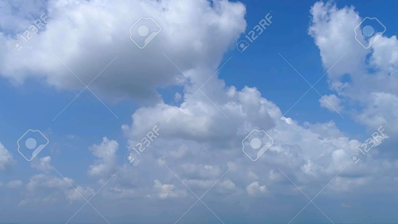 Blue Sky with White Fluffy Clouds as a Back Ground - 165159440 Blue Sky with White Fluffy Clouds as a Back Ground - 165159440