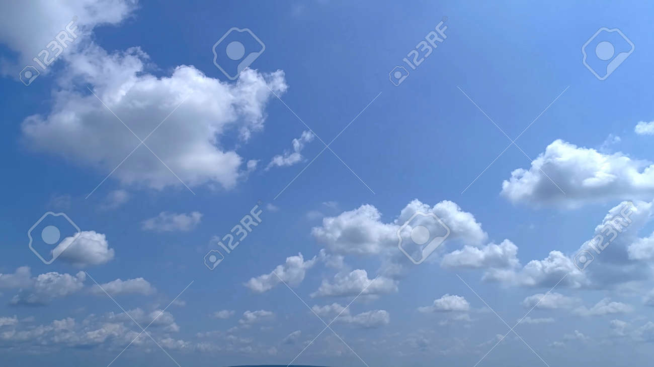 Blue Sky with White Fluffy Clouds as a Back Ground - 165159441 Blue Sky with White Fluffy Clouds as a Back Ground - 165159441