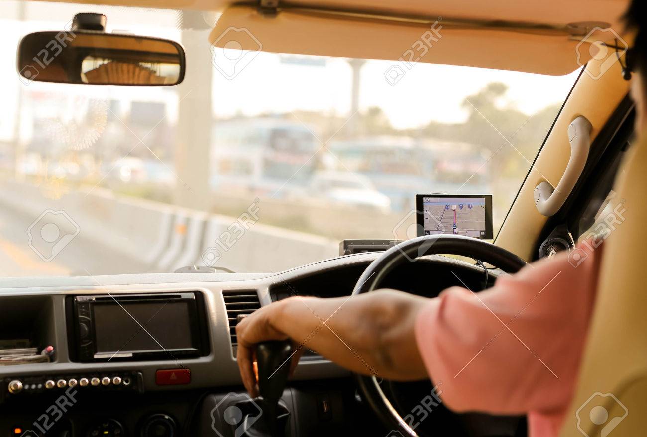 Man driving a car with navigation device on road trip - 57611163 Man driving a car with navigation device on road trip - 57611163