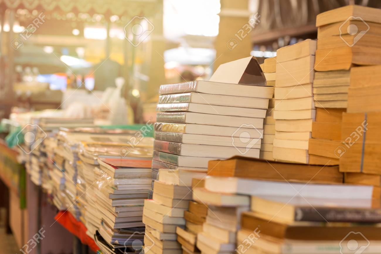 Piles of old books on a table in a market - 94505755 Piles of old books on a table in a market - 94505755