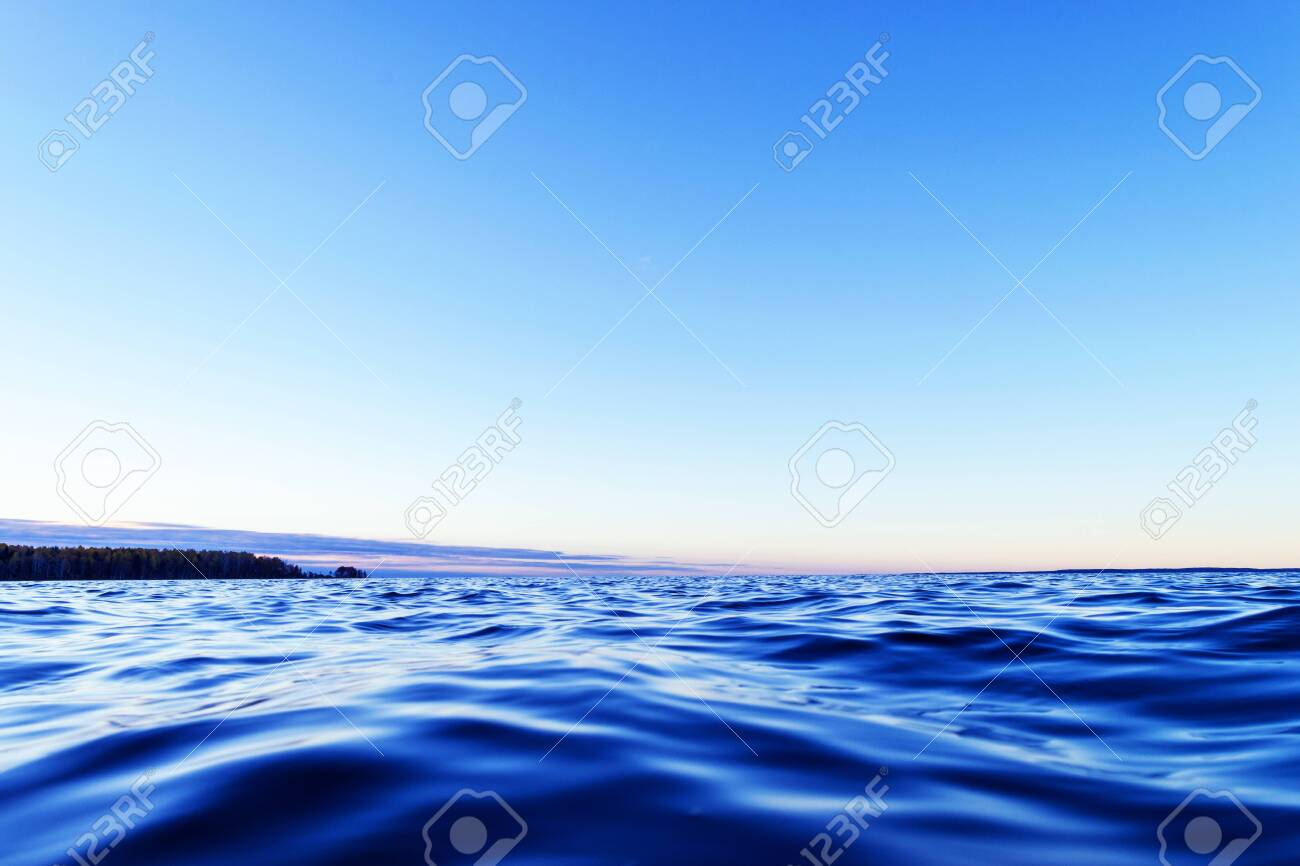 Water Surface. View Of A Sunset Sky Background. Dramatic Gold Sunset Sky  With Evening Sky Clouds Over The Sea. View Of A Crystal Clear Sea Water  Texture. Landscape. Small Waves. Water Reflection, image size:1300x866