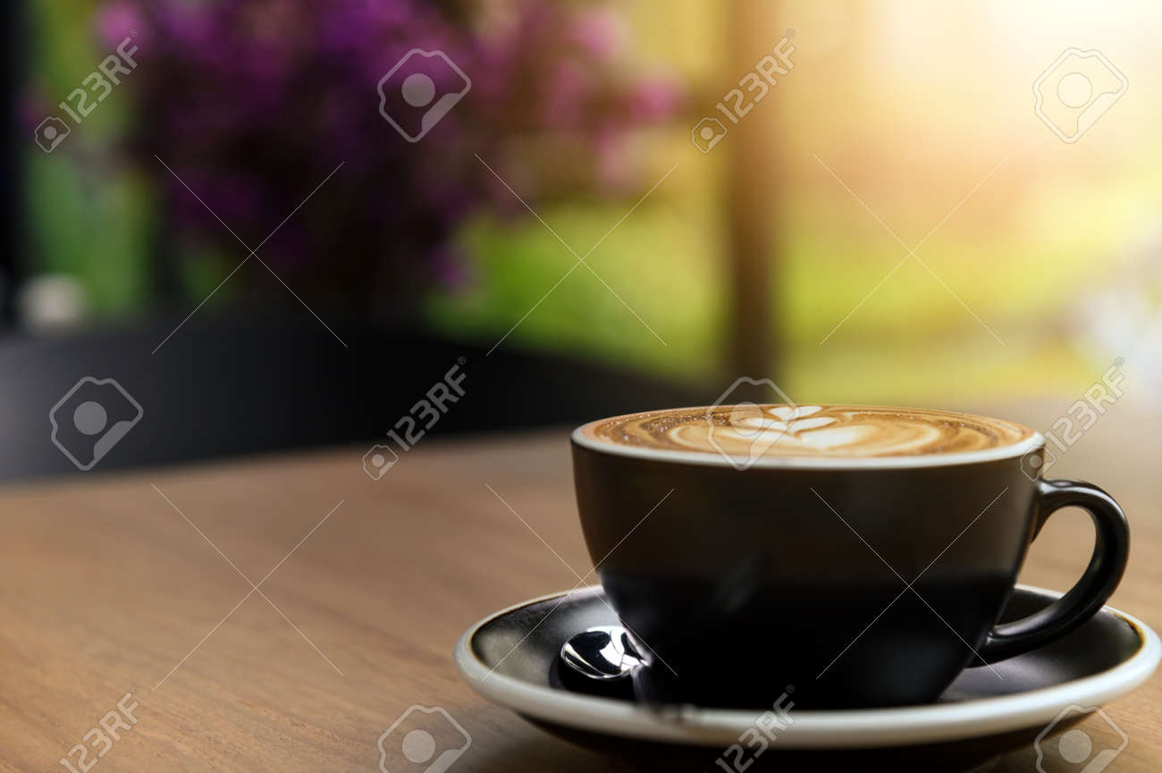 Nice cup of fresh brewed coffee with beautiful latte art on wooden table in cafe with copy space. Coffee break recreation relaxation - 165342478 Nice cup of fresh brewed coffee with beautiful latte art on wooden table in cafe with copy space. Coffee break recreation relaxation - 165342478