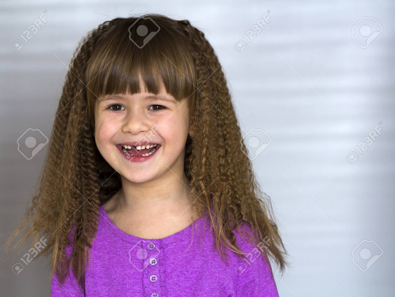 Portrait Of Happy Smiling Little Girl With Beautiful Thick Hair