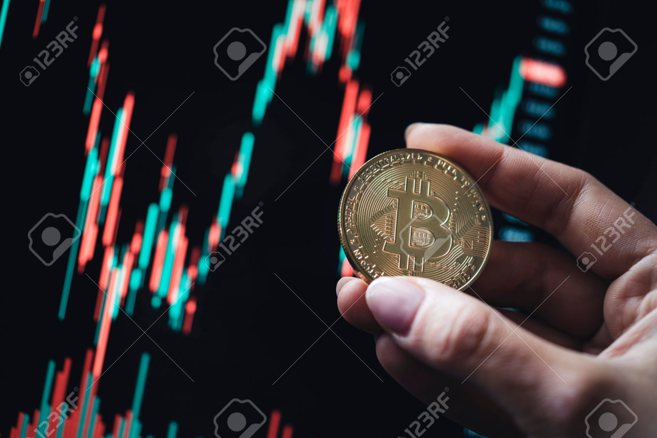 Hand Holding A Gold Bitcoin Cryptocurrency Coin With Candle Stick Graph  Chart And Digital Background. Stock Photo, Picture and Royalty Free Image.  Image 198498242.