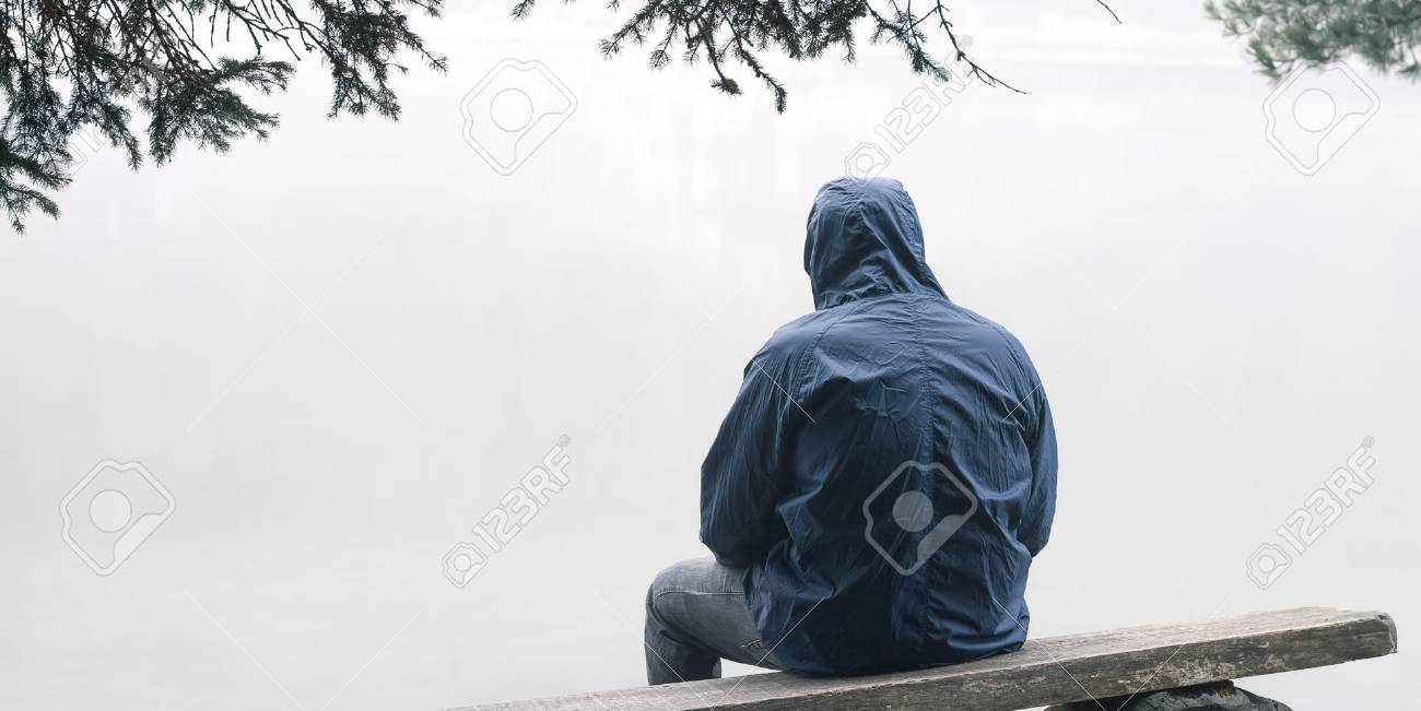 Depressed man sitting on bench in hooded jacket - 88649354 Depressed man sitting on bench in hooded jacket - 88649354