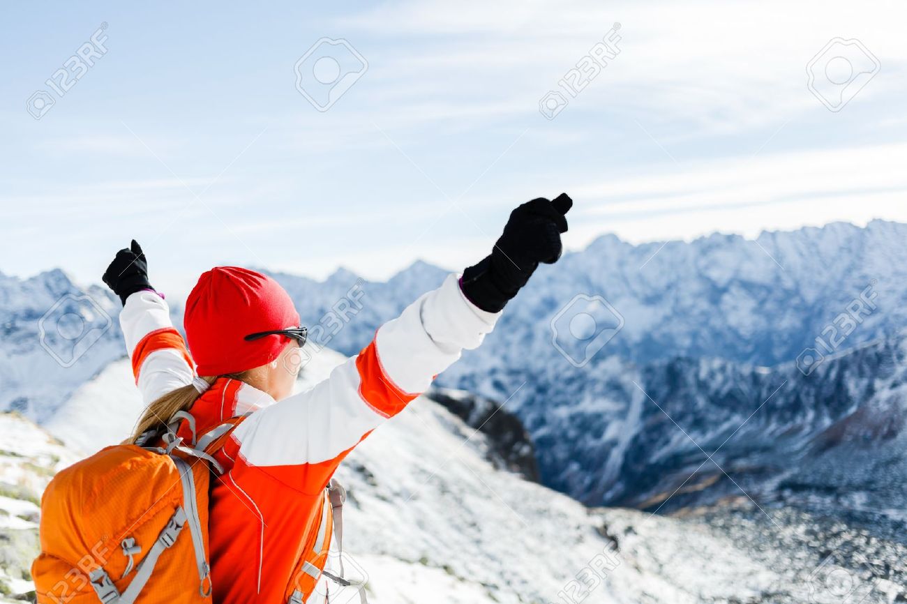 Hiking woman and success in winter mountains. Fitness and healthy lifestyle outdoors in snowy nature. Female mountaineer or climber on top of mountain peak happy with arms raised. - 16715154 Hiking woman and success in winter mountains. Fitness and healthy lifestyle outdoors in snowy nature. Female mountaineer or climber on top of mountain peak happy with arms raised. - 16715154