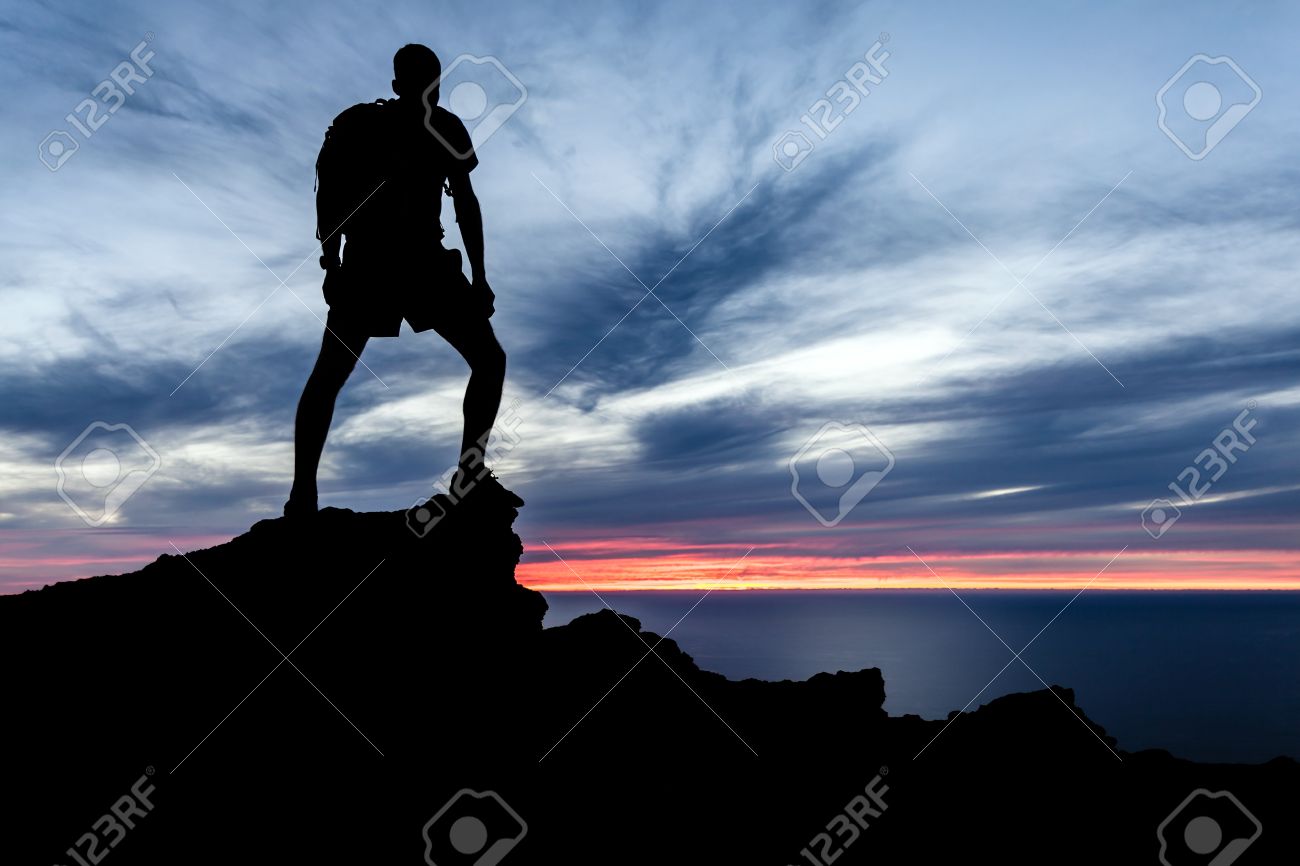 Male Silhouette Hiker With Backpack On Top Of Mountain Looking Stock Photo Picture And Royalty Free Image Image