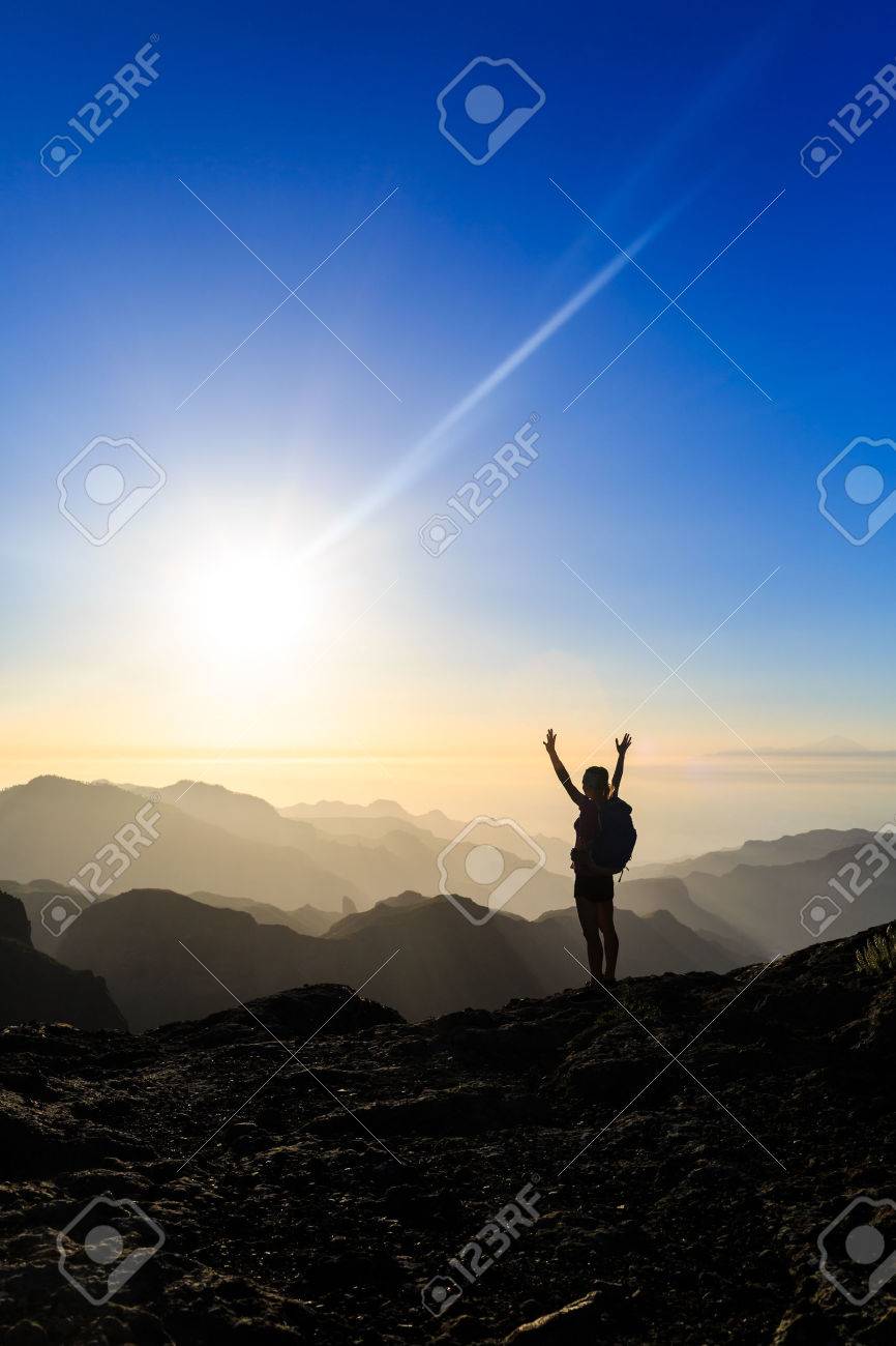 Woman successful hiking climbing silhouette in mountains, motivation and inspiration in beautiful sunset and ocean. Female hiker with arms up outstretched on mountain top looking at beautiful night sunset inspirational landscape. - 43648604 Woman successful hiking climbing silhouette in mountains, motivation and inspiration in beautiful sunset and ocean. Female hiker with arms up outstretched on mountain top looking at beautiful night sunset inspirational landscape. - 43648604