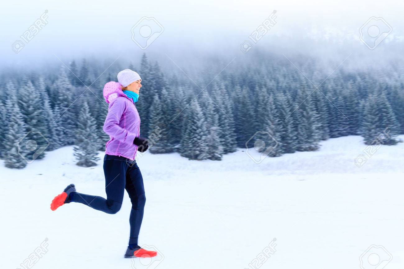 Sport, fitness inspiration and motivation. Young happy woman cross country running in mountains on snow, winter day. Female trail runner jogging exercising outdoors. - 43899652 Sport, fitness inspiration and motivation. Young happy woman cross country running in mountains on snow, winter day. Female trail runner jogging exercising outdoors. - 43899652